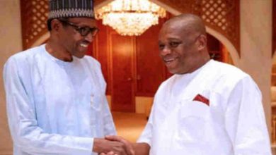 President Buhari in a warm handshake with Senator Orji Uzor Kalu